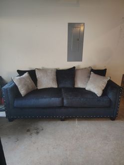 Navy blue couch and loveseat with pillows