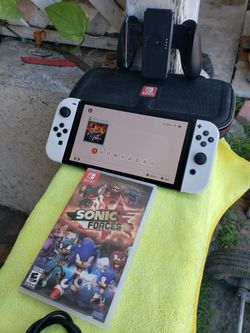 1 Game. 1 charger. 1 case. 1 SD Card. No Dock. Is 2024 OLED Nintendo Switch 128GB big screen white edition. $225! Firm. Or Trade Pokémon Card or cards