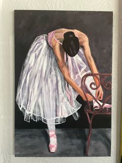 Ballerina tying pointe shoe