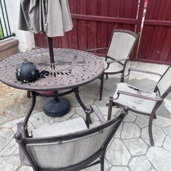 Free Table And Three Chairs. The Chairs Are Ripped No Umbrella.
