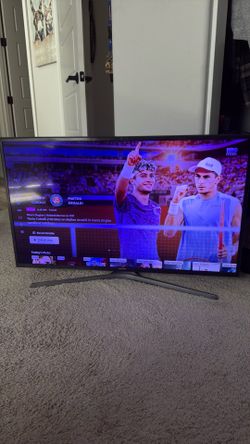 Samsung 40in smart TV on stand.