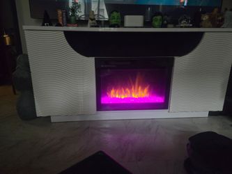 Selling entertainment center with heat working fire place with changing color stones $400 neg