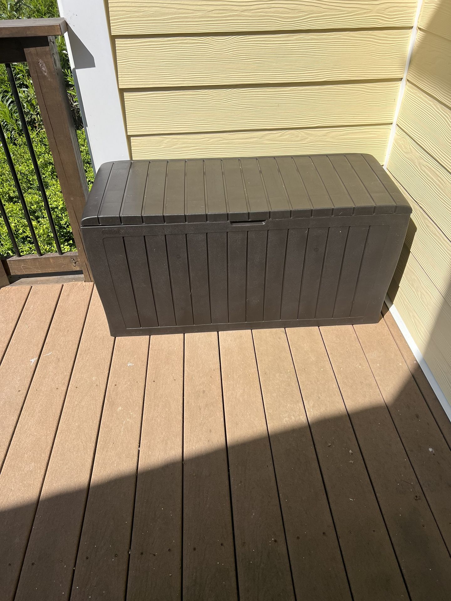 Brown Outdoor Deck Box Storage -Weather-Resistant"  For sale: A brown, durable Outdoor Deck Box, great for storing outdoor items. 