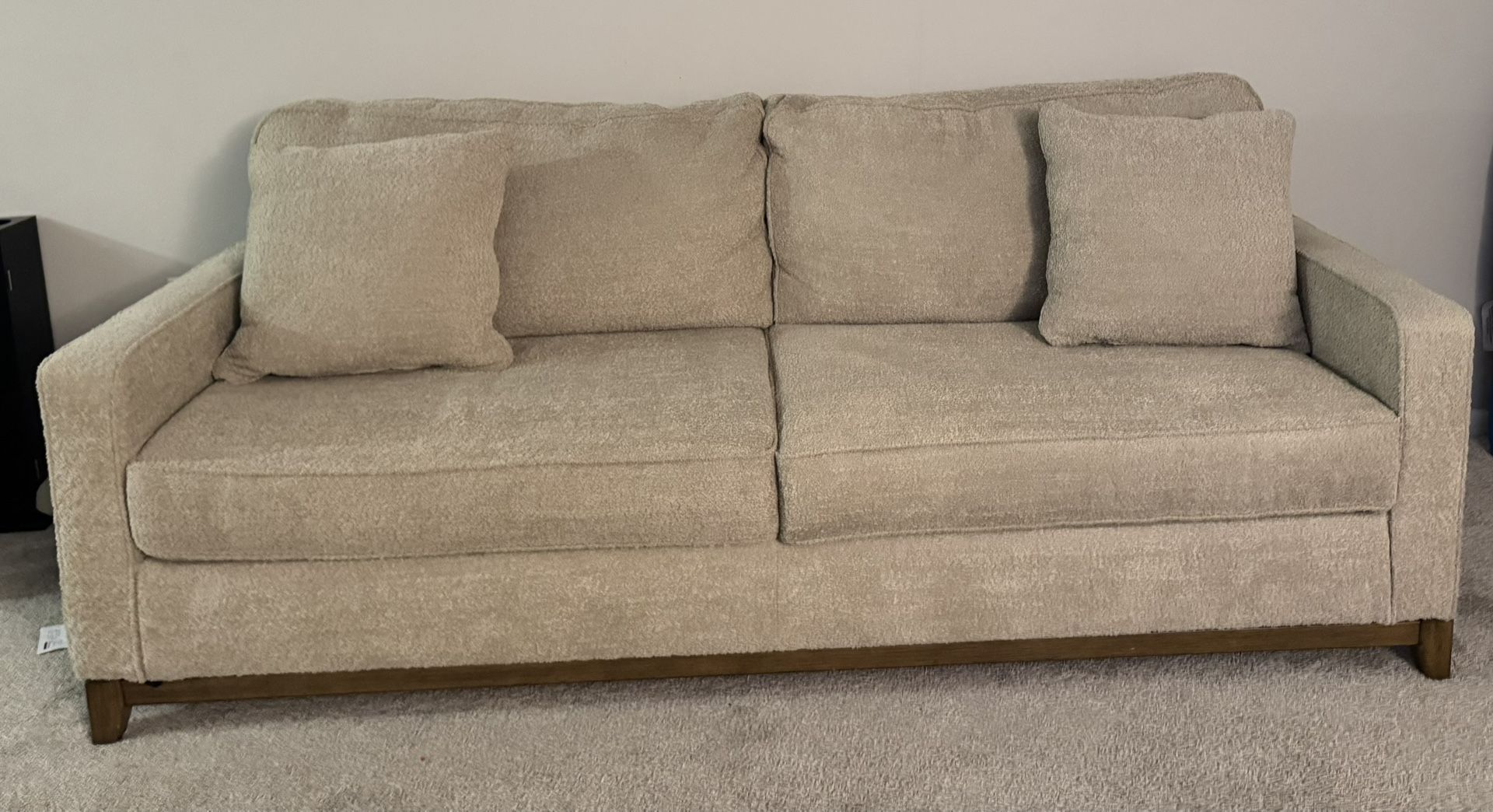 Beige Sofa with two accent pillows