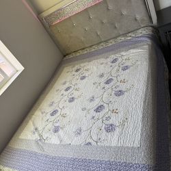 queen bed with colorful lights at back