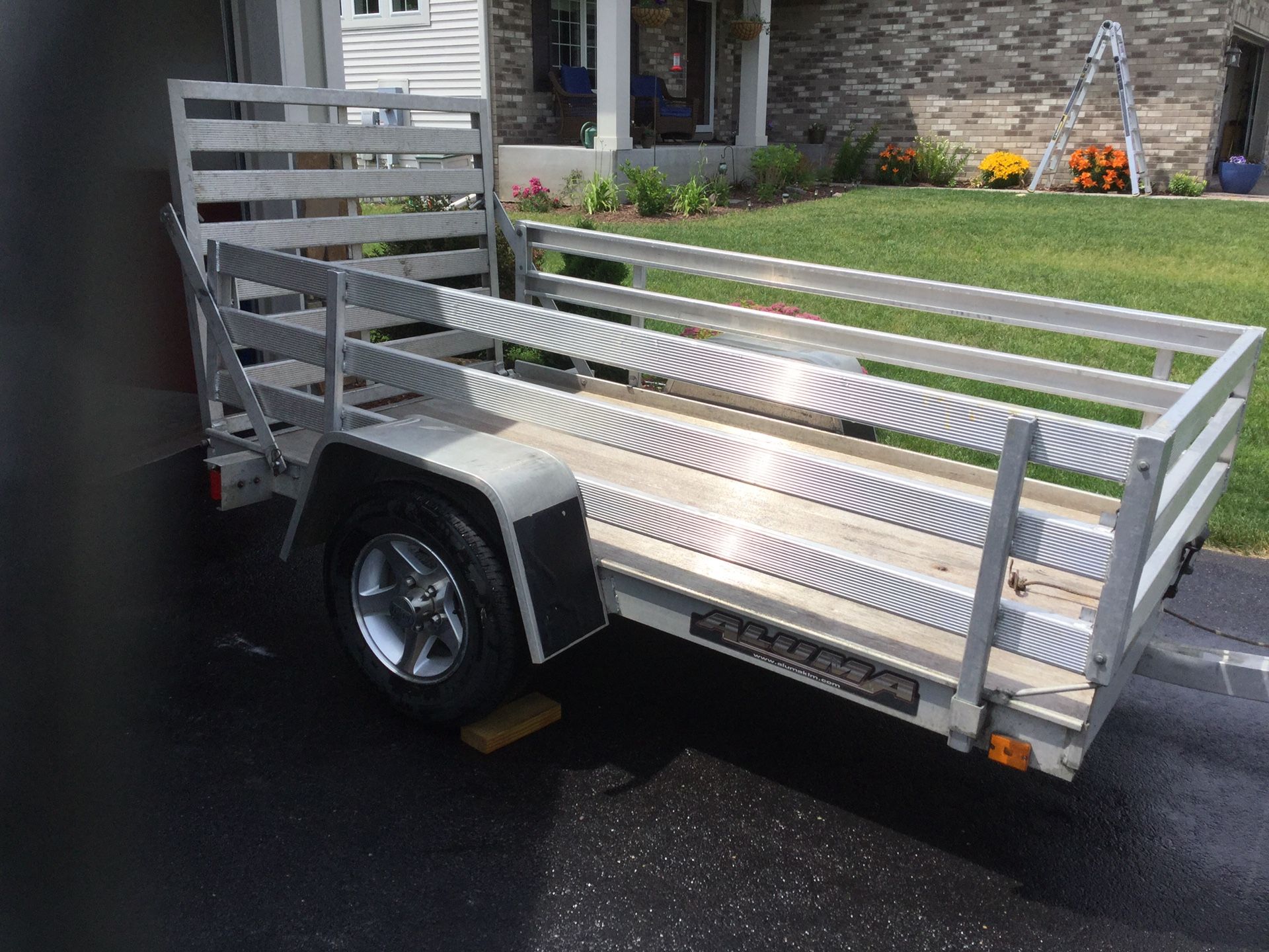 Aluma utility trailer 54 inches x 8 ft long with hand winch and new tires.