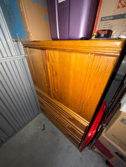 Oak armoire with a top cabinet and lower drawers