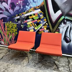 Orange Allermuir chairs with metal frame