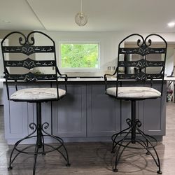 Two black metal bar stools Both for $300