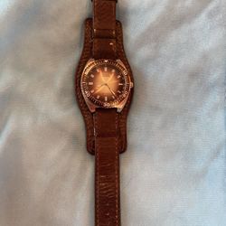 Guess watch w/ leather band. Good condition. Needs battery.