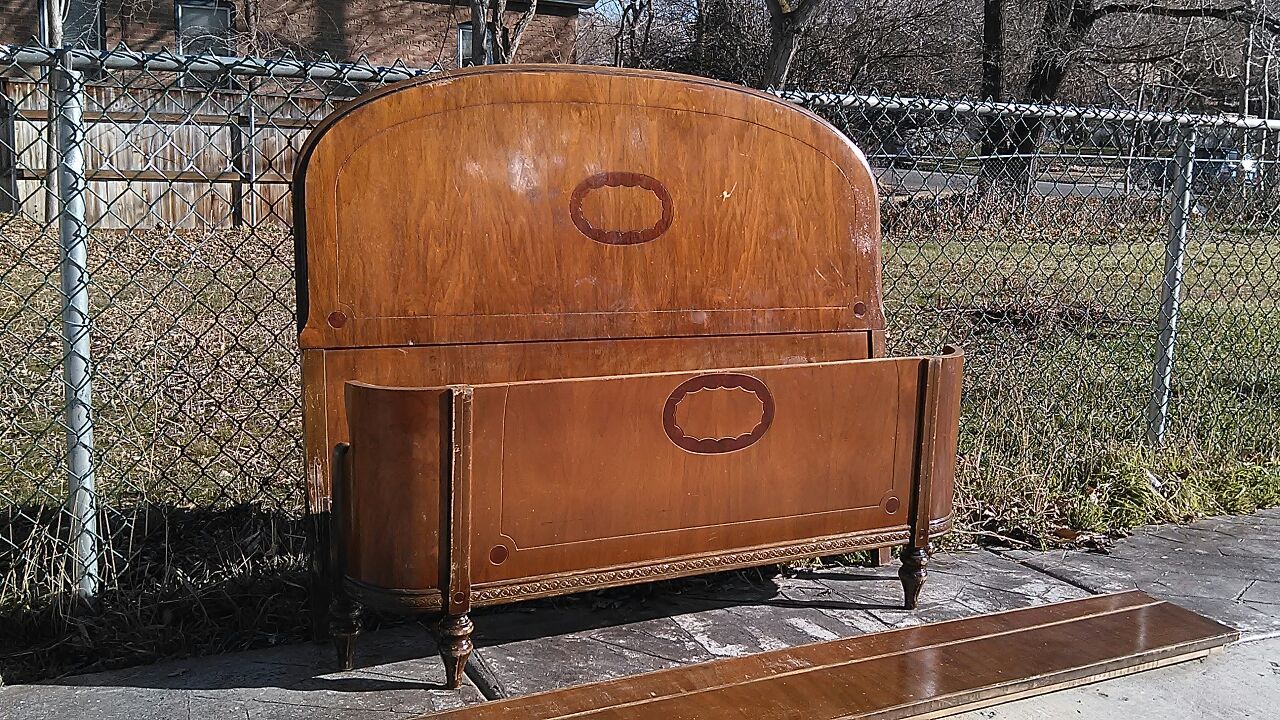 Antique bed with rounded footboard
