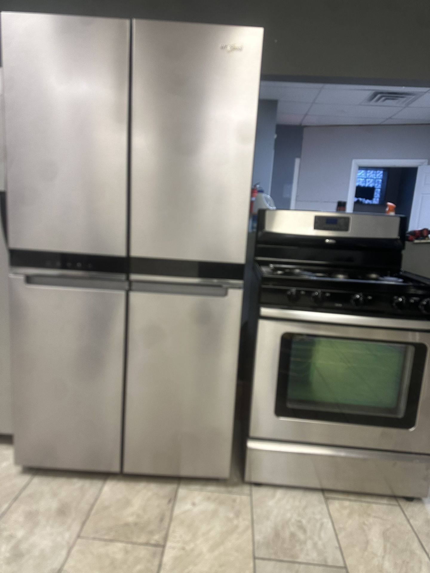 Whirlpool 4 door counter depth refrigerator & Whirlpool 5 burner gas range set stainless steel