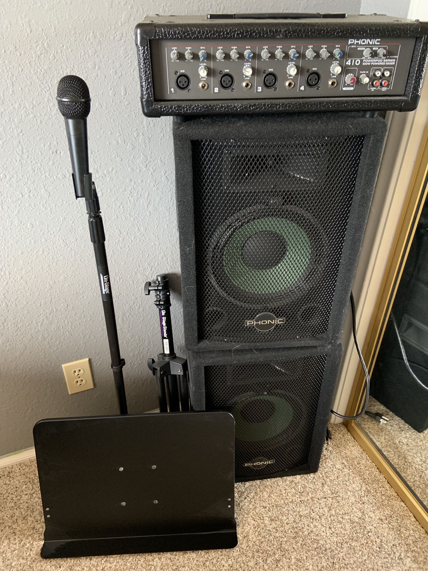 PA system with two speakers and microphone microphone stand and music note stand