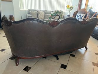 Brown Leather Loveseat with Carved Wood Frame