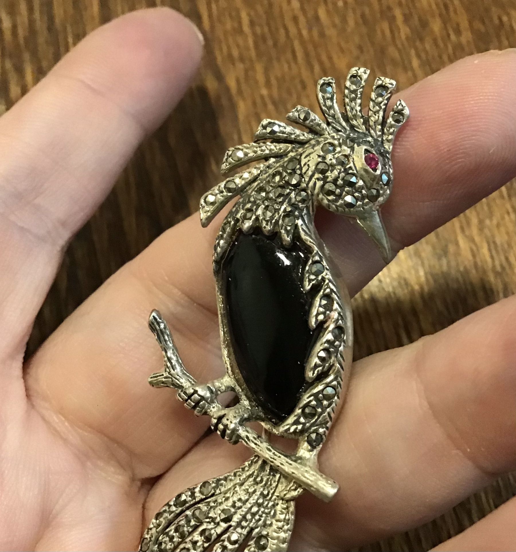 Sparkling sterling marcasite onyx parrot with a ruby eye brooch pin