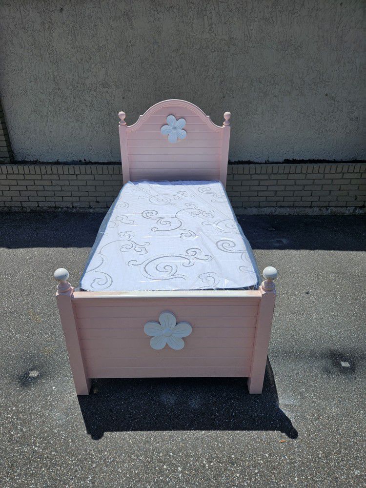 Pink twin-size bed frame with brand New twin size plush mattress and box spring 