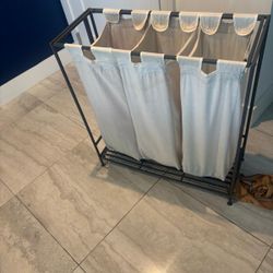 Three compartment metal rack, laundry baskets… 29” wide , 12” depth, 31” high. $30
