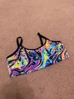 Vibrant neon marble print crop top by iHeartRaves. Slim, supportive fit with thin black straps. Smooth, stretchy fabric for easy movement. Bold multic