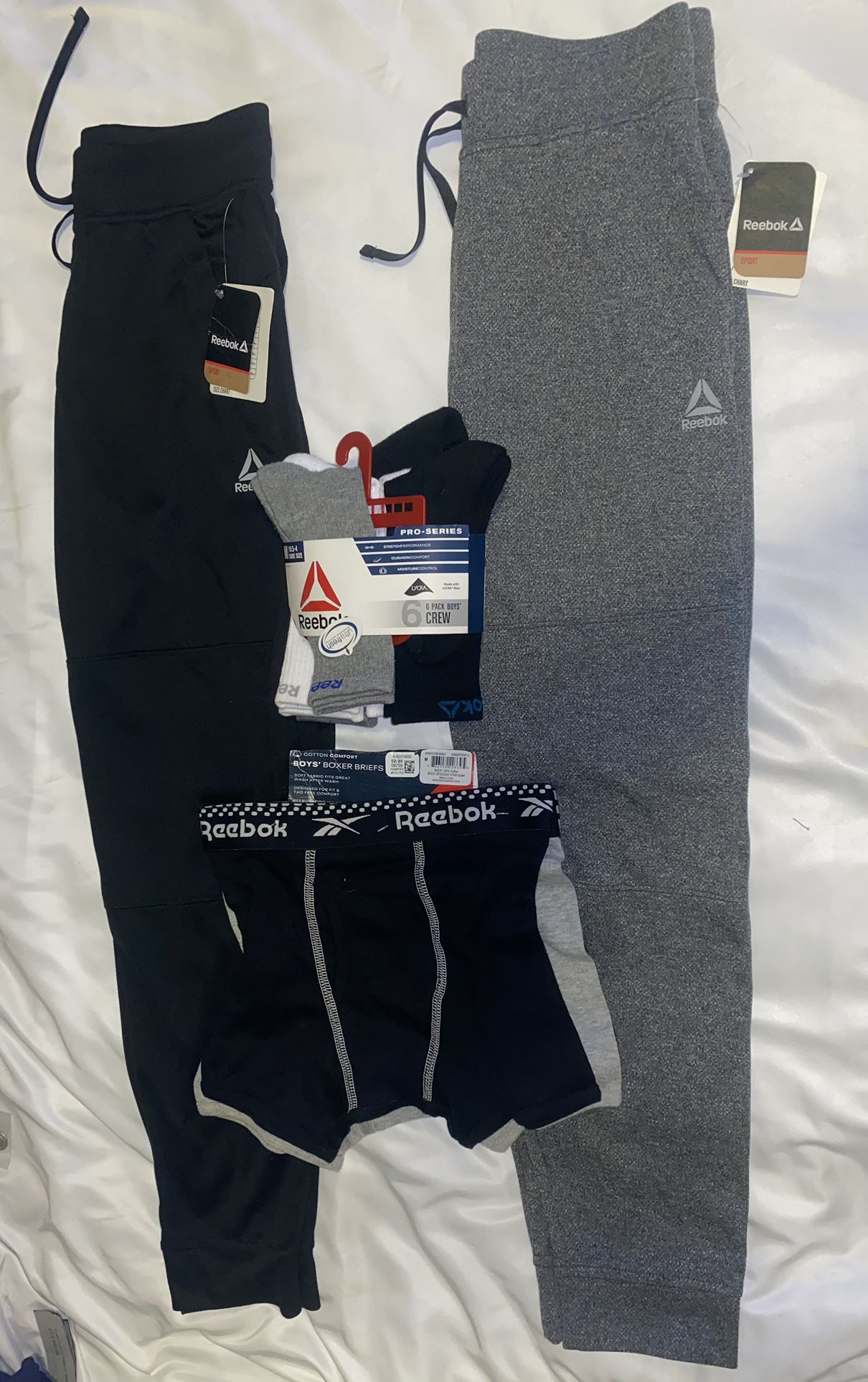 Reebok Lot of 4 Boys. Two Joggers, 3 Pack of Boxer, Briefs, 6 Pack of Crew Socks.