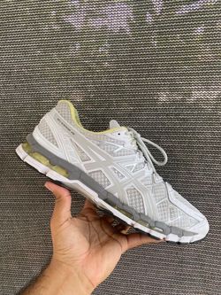 ASICS Gel-Kayano 20 running shoes in white, grey, and yellow.