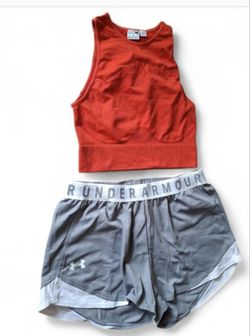 “Bright orange Puma athletic T-shirt and gray Under Armour short shorts, practic