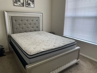 Bedroom queen size bed with box and mattress and dresser and mirror