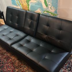 Black Futon With Leather Like Upholstery. Only A Few Months Old.