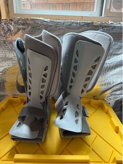 Two Aircast walking boots (size Large) and a pair of adjustable aluminum crutches.