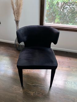Two black velvet chairs from Moe’s