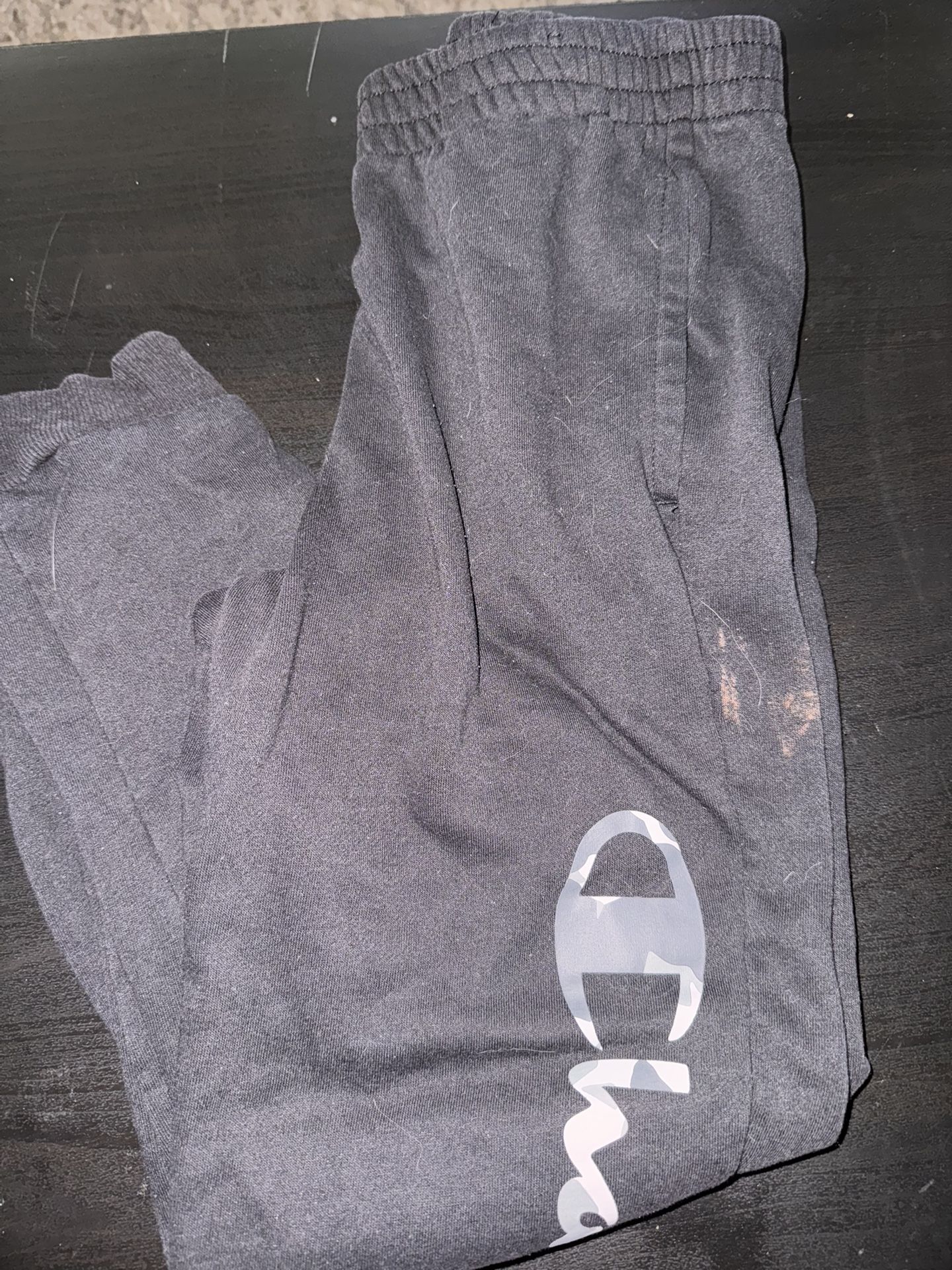 Boys joggers and hoodie bundle size 10/12 14/16 and 18/20 champion and Nike  Black champion joggers have a bleach stain  Grey hoodie has a stain on fr