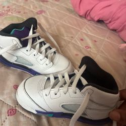 White, purple, an teal color kid Jordan’s