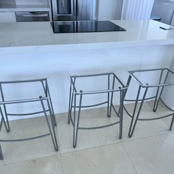 Set of 3 metal frame stools with fiberglass top. Very modern.