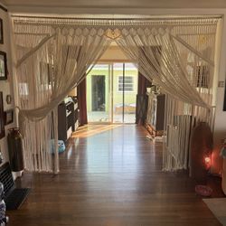 Handmade macramé curtain for indoor or outdoor use.