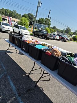 Outside clarence, sale, instant and children's clothing are two items for1 dollar on tables