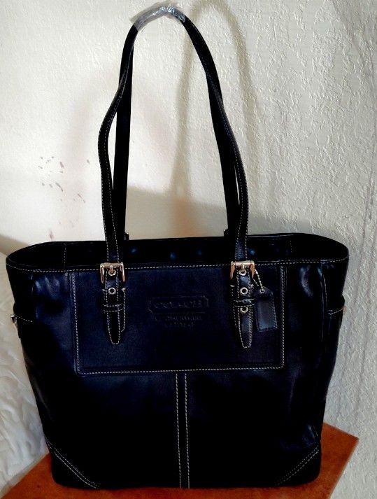black leather Coach brand bag