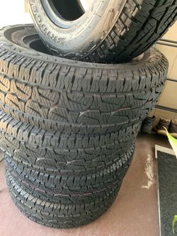 5 BRIDGESTONE TIRES (set of 4 + matching spare) in new condition.