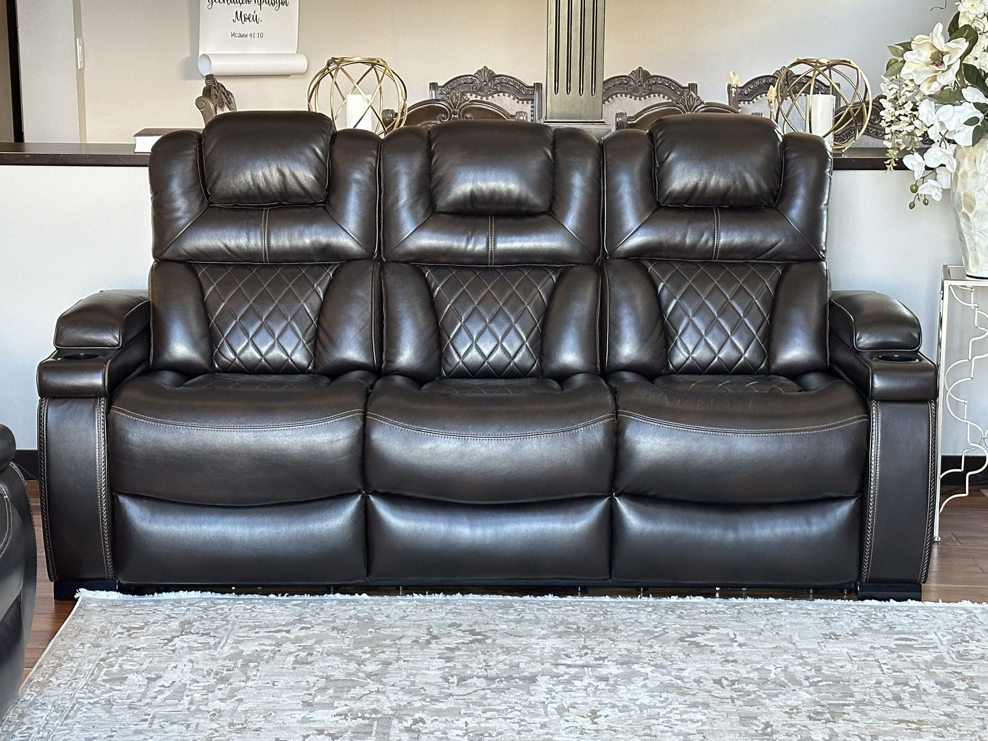 Dark brown leather sofas.
