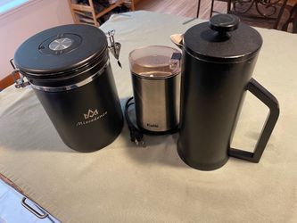 French press, coffee bean grinder, and coffee canister.
