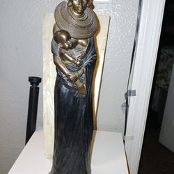 Wooden African woman holding her child sculpture