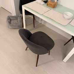 Selling a table with a glass top and four chairs.