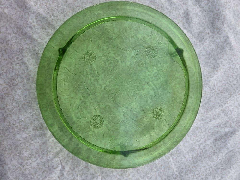 Green Glass Stand With Flowers On It