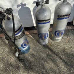 Three Scuba Tanks. One All Set Up Ready To Go With Back And Regilator