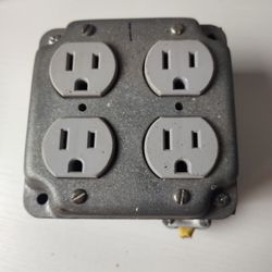 Distribution box with four grounded electrical outlets.