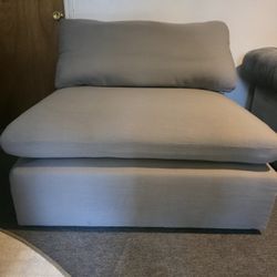 Raleigh armless armchair upholstered in grey bouclé