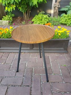 New walnut wood finish round side table.