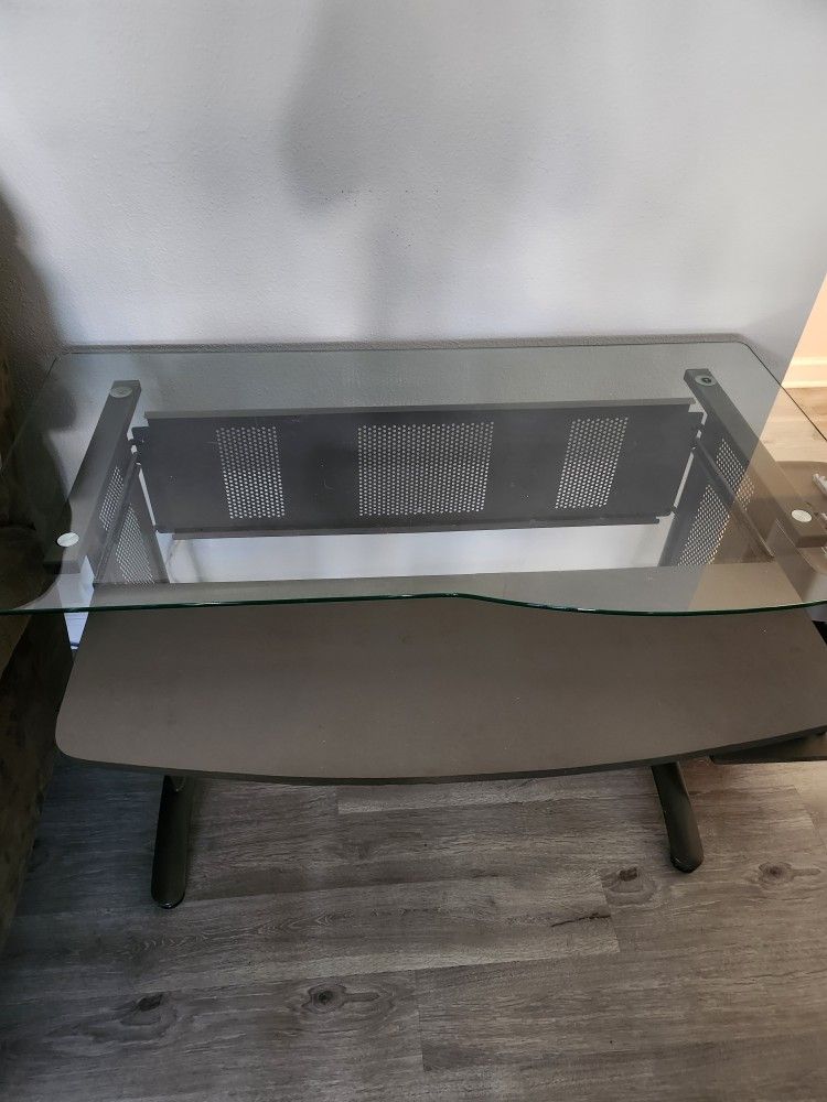 Glass top desk with pull out keyboard tray and elevated side shelf