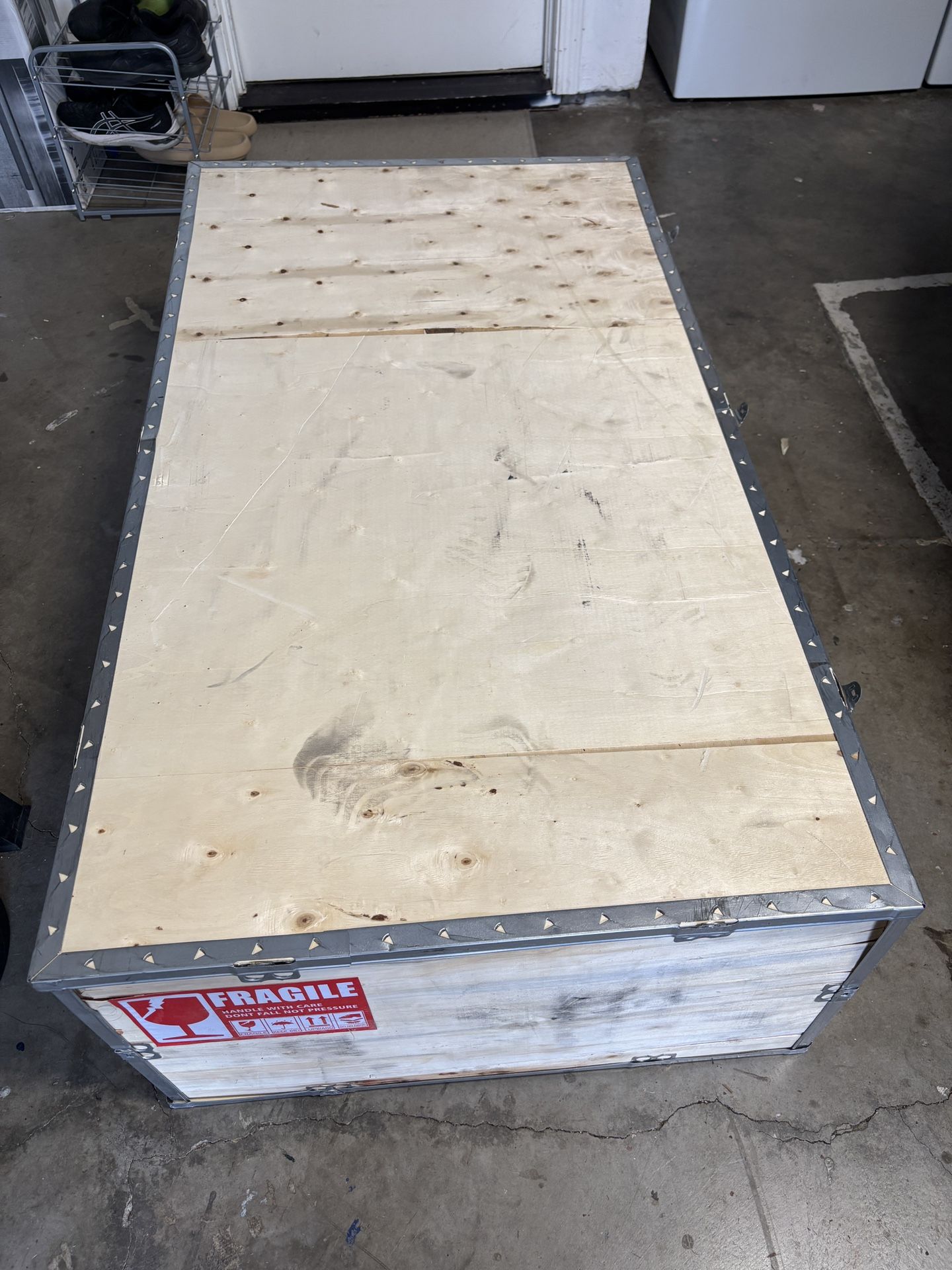Heavy duty wooden shipping crate with metal reinforcements and secure fasteners