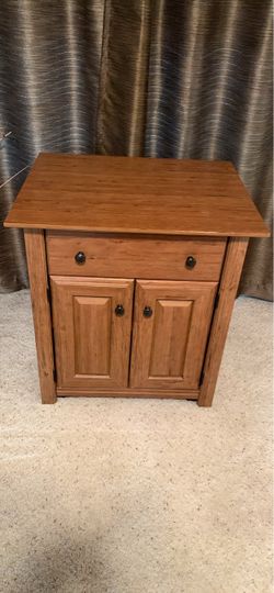 Mini sideboard featuring a single drawer and a two-door cabinet accented with dark round hardware.