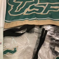 Five pieces of USF, swag memorabilia, including a flag to clear bags and too many towel