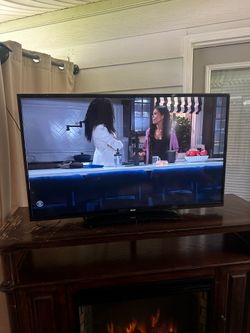 Wooden fire place TV stand / and 48 inch RCA smart TV